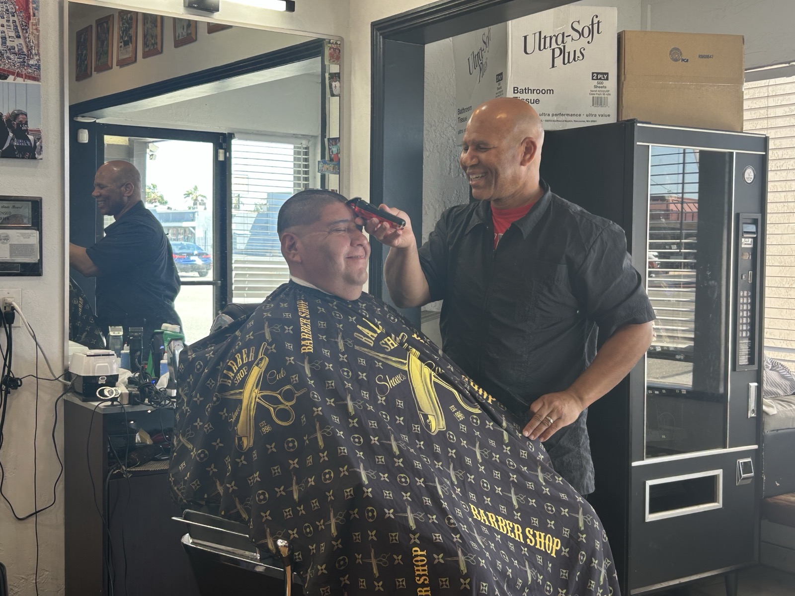 Magic finishing a classic cut at Style Masters Barbershop